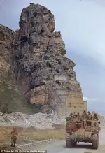 American troops ride an armored car down the road originally built by ancient Romans to reach...webp American troops ride an armored car down the road originally built by ancient Romans to reach...webp