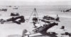 Bf-109E7B-7_JG26-(W12+I)-WNr-4148-undergoing-maintanence-Gela-Sicily-1941-01.jpg